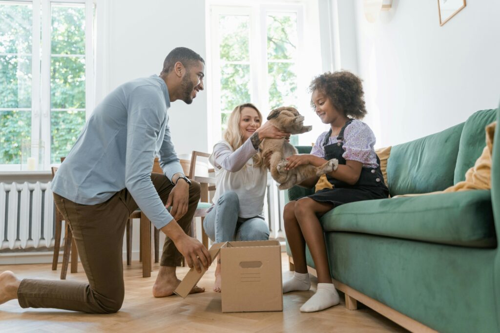 A young family in their new living room with their new pet rabbit