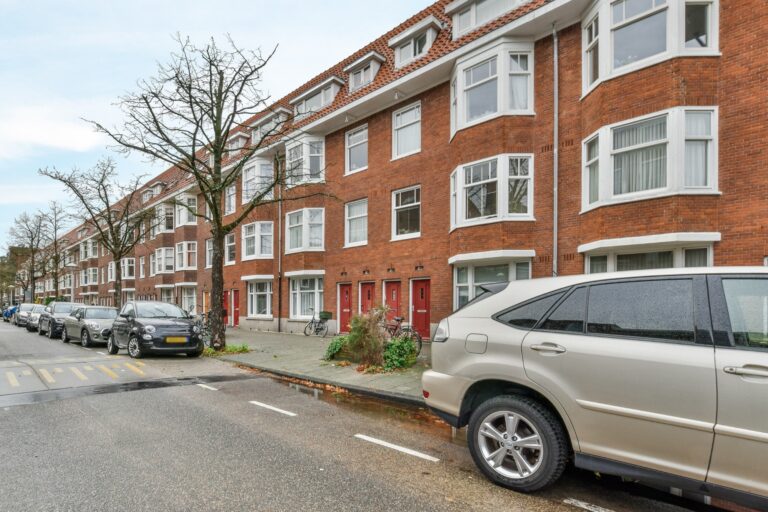 Brick houses with cars on the street in the concept of 'best affordable housing options in Walthamstow'.