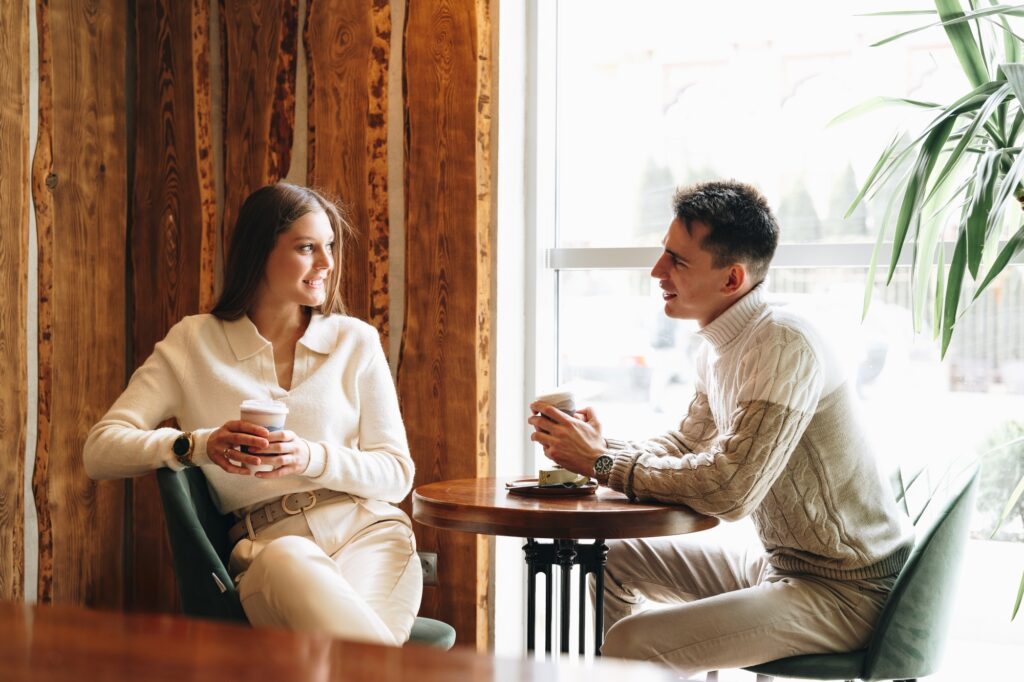 Two people enjoying a conversation in a cosy cafe