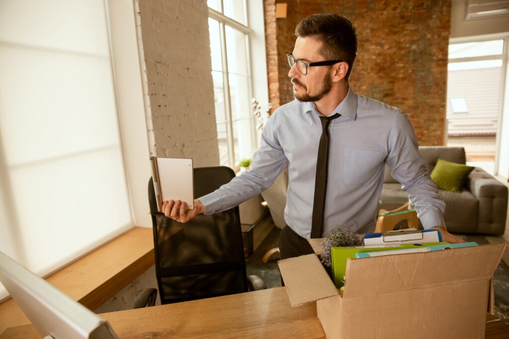 A male employee setting up his workstation at the new office