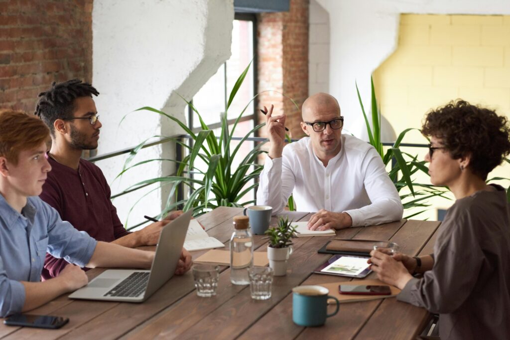 The project manager in a meeting with the moving committee in the concept of 'how to minimise disruption during an office move to Walthamstow'.